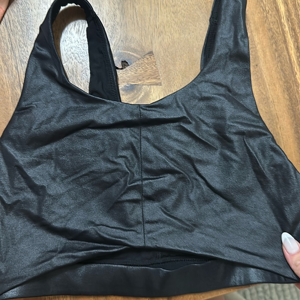 Victoria Secret size M sports bra. Black shiny material . Like new